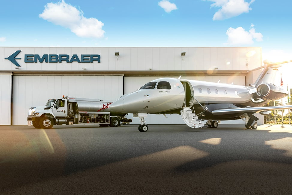 jato da embraer ao lado de caminhão-tanque de combustível. Embraer e Avfuel ampliam uso de combustível sustentável na aviação